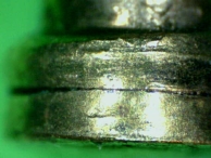 Damage to the serrations of a spool pin with serrated edges.
