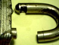 A padlock was repeatedly struck with a hammer until the shackle broke.