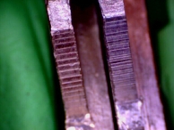 A comparison of two keys cut with different speed key machines. Notice the difference in the grain of the cuts.