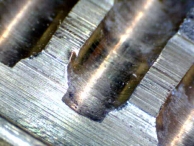 A deformation caused by a pick tool, found on the chamber in a pin-tumbler cylinder.
